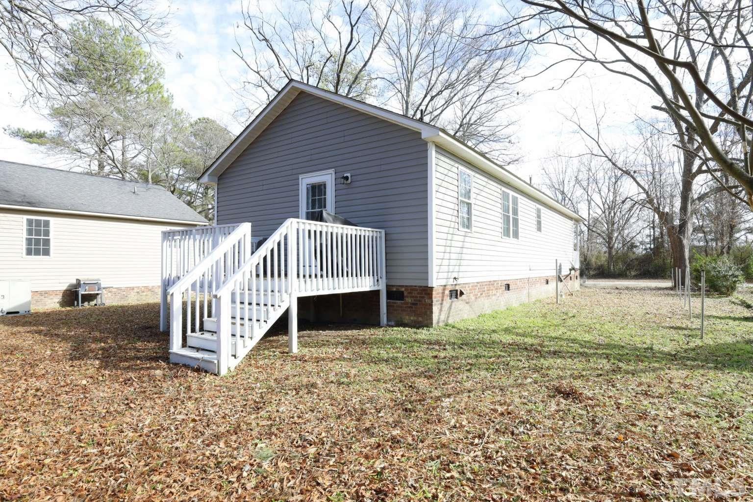802 South Webb Street Selma, NC 27576 - Photo 21 of 25 a house with white fence and porch