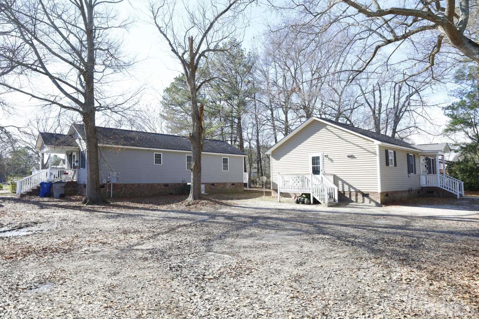 802 South Webb Street Selma, NC 27576 - Photo 25 of 25 a view of a white house with a yard covered in snow