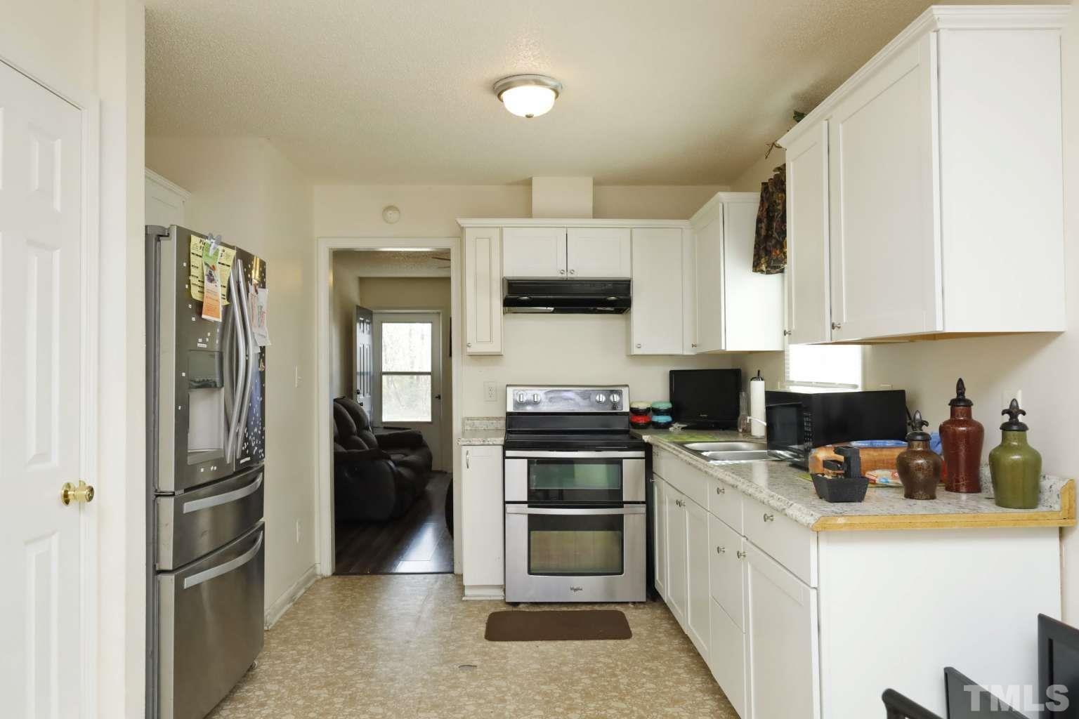 802 South Webb Street Selma, NC 27576 - Photo 6 of 25 a kitchen with stainless steel appliances a refrigerator stove and sink