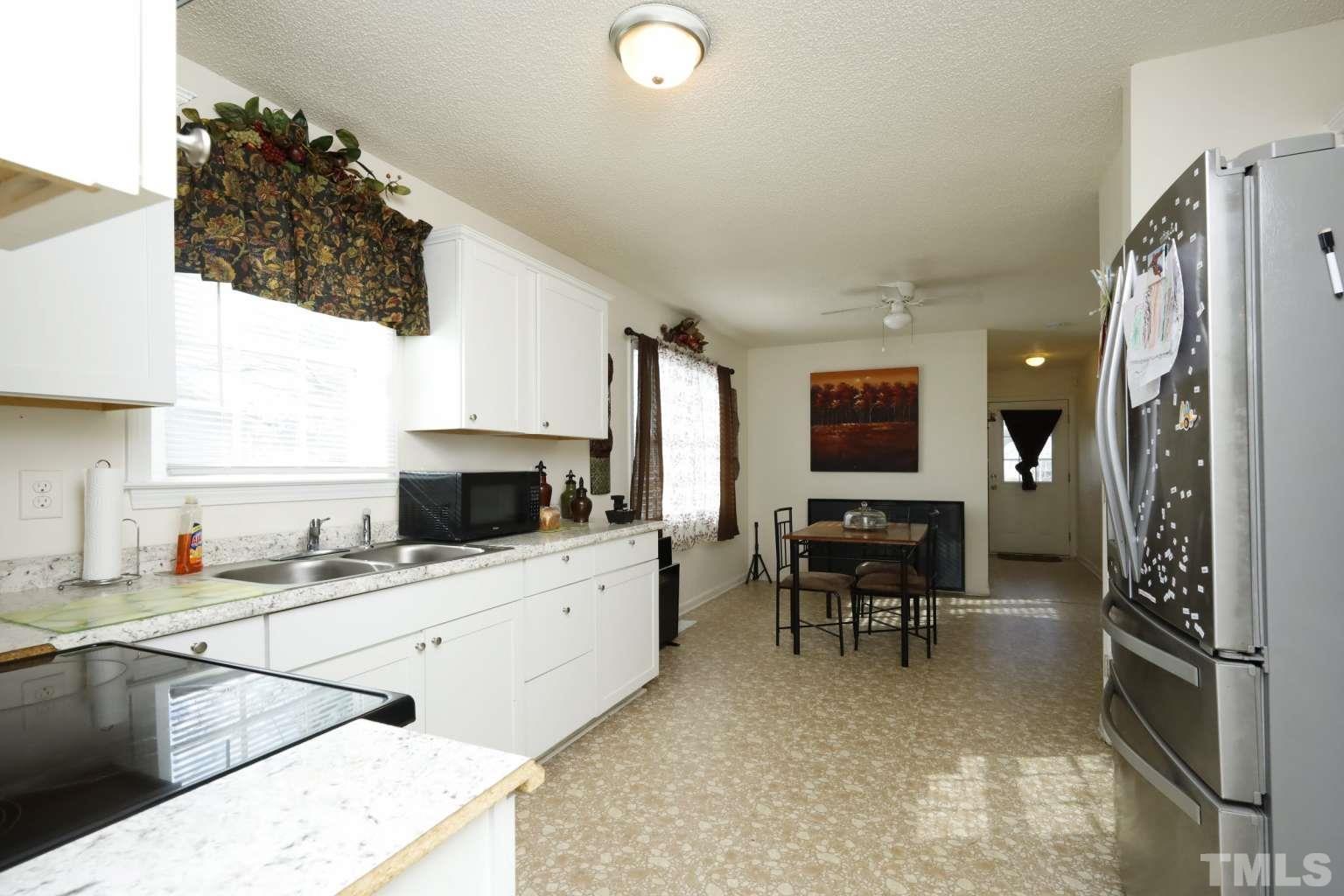 802 South Webb Street Selma, NC 27576 - Photo 8 of 25 a kitchen with granite countertop a sink stove and cabinets