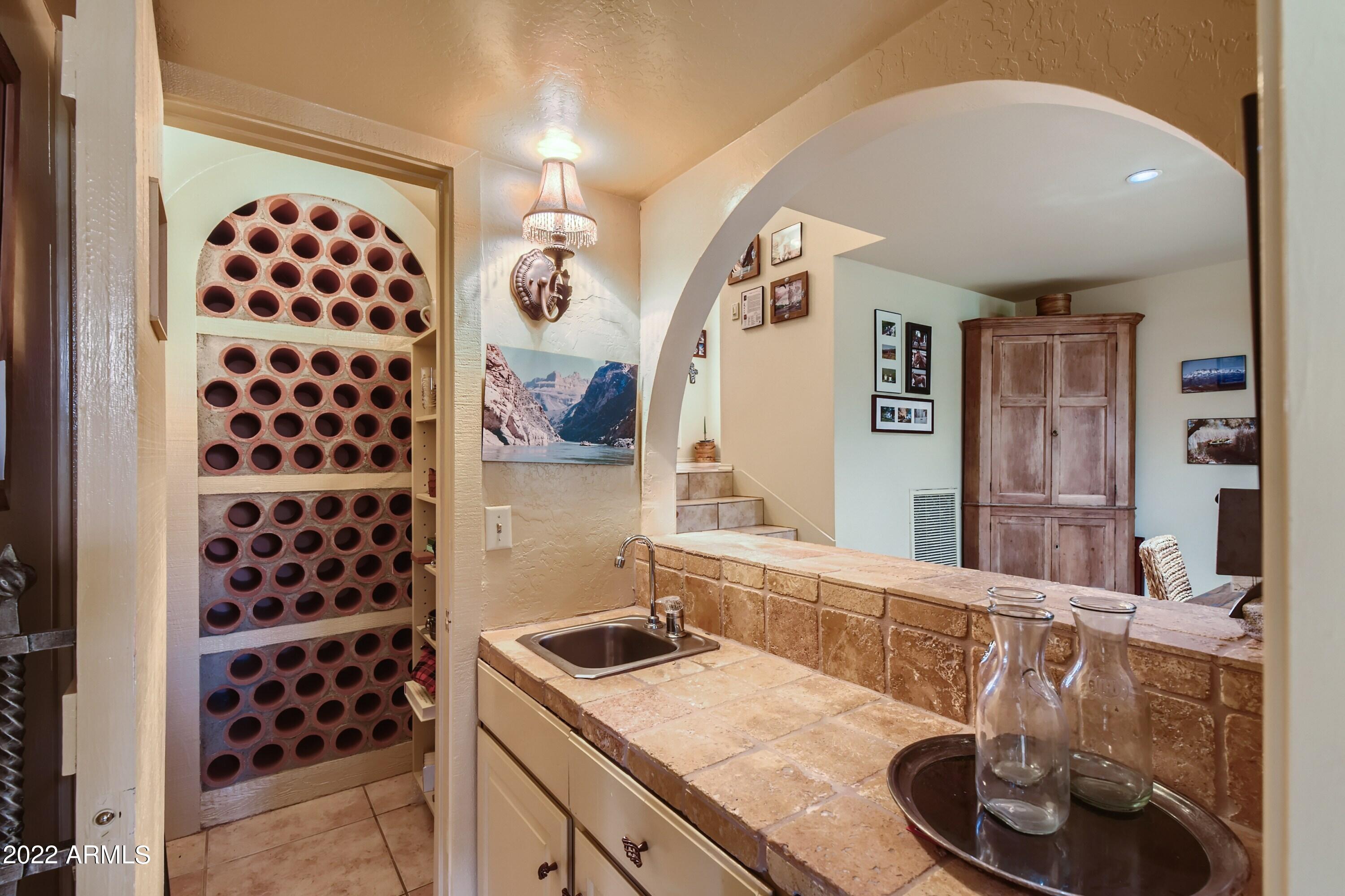 4438 East Camelback Road, Unit 152 Phoenix, AZ 85018 - Photo 15 of 30 Wine storage & bar open to liv rm