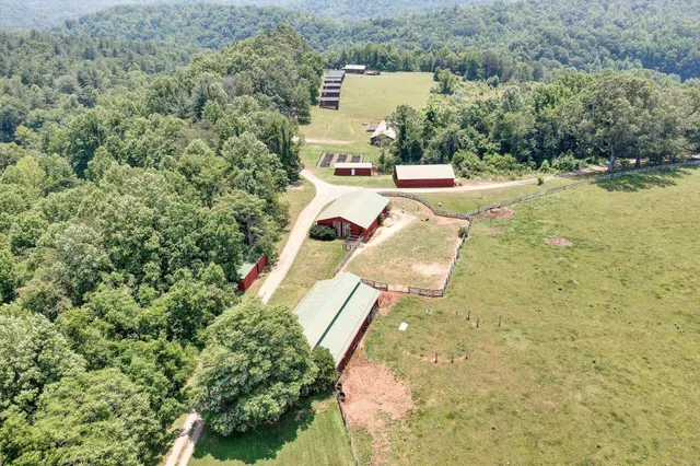 a view of a house with a big yard and sitting area