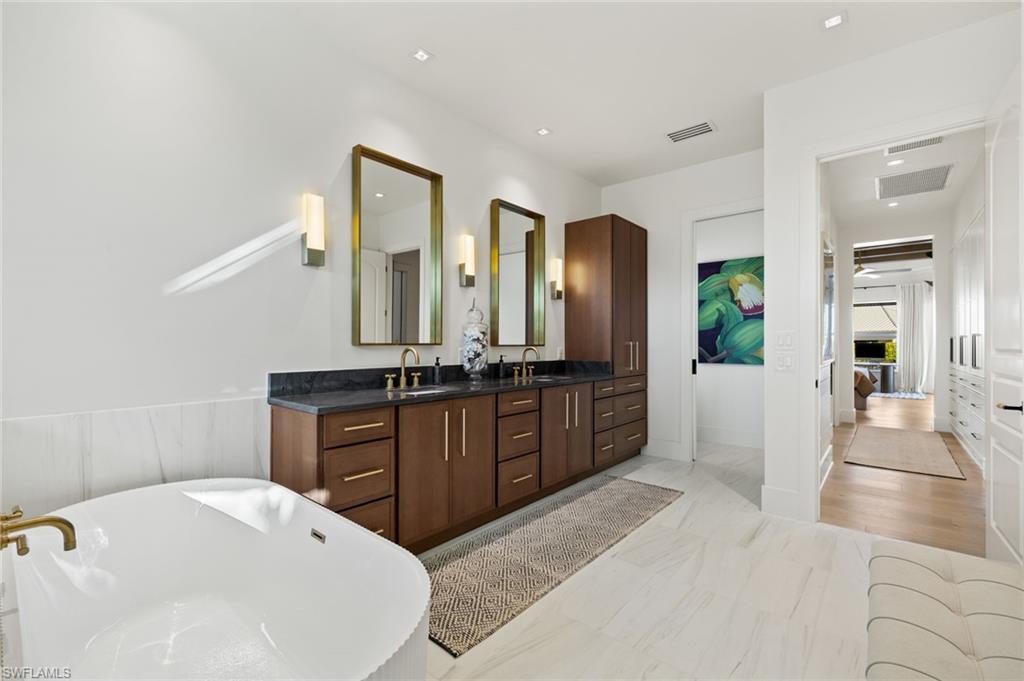 1955 Tarpon Road Naples, FL 34102 - Photo 13 of 48 Ensuite bathroom featuring double vanity, a freestanding bath, and recessed lighting