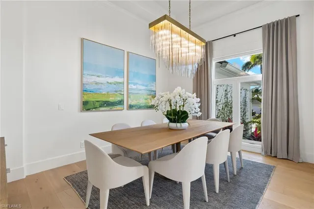 a view of a dining room with furniture and a potted plant