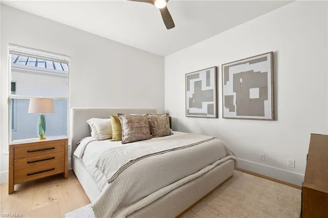 a front view of a house with a yard and palm trees