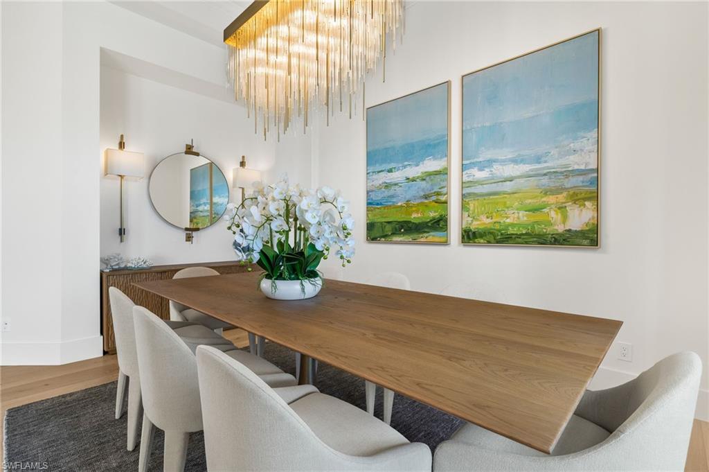 1955 Tarpon Road Naples, FL 34102 - Photo 28 of 48 Dining space with light wood-style floors and a chandelier