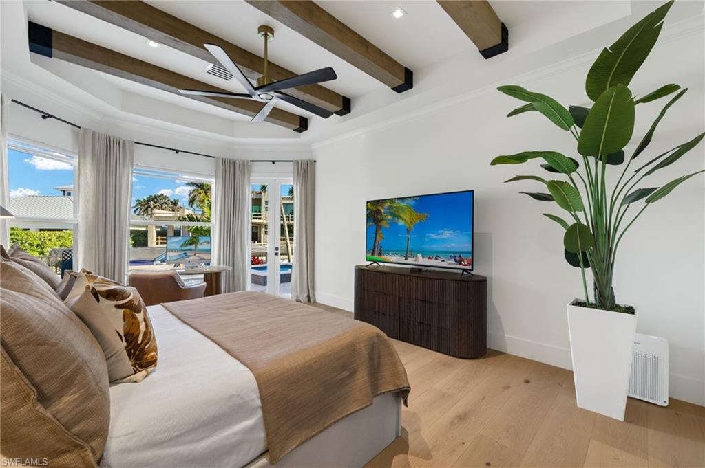 1955 Tarpon Road Naples, FL 34102 - Photo 8 of 48 Bedroom featuring wood finished floors, beamed ceiling, a ceiling fan, and recessed lighting