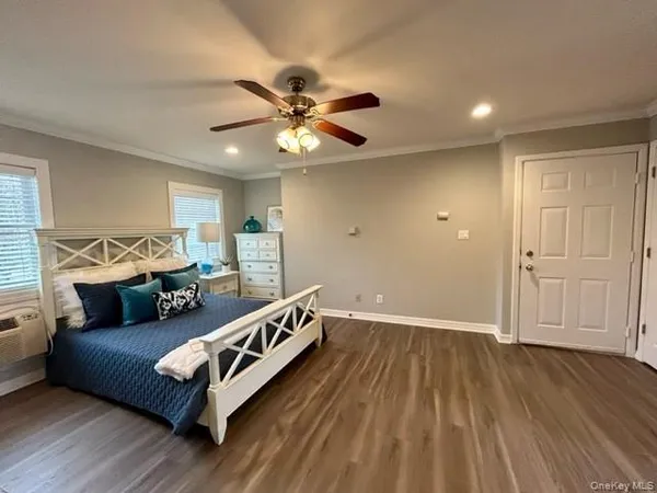 a bedroom with a bed couch and window