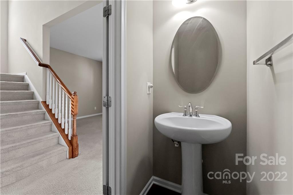 7720 East Berkeley Road Denver, NC 28037 - Photo 19 of 40 a bathroom with a sink and a mirror