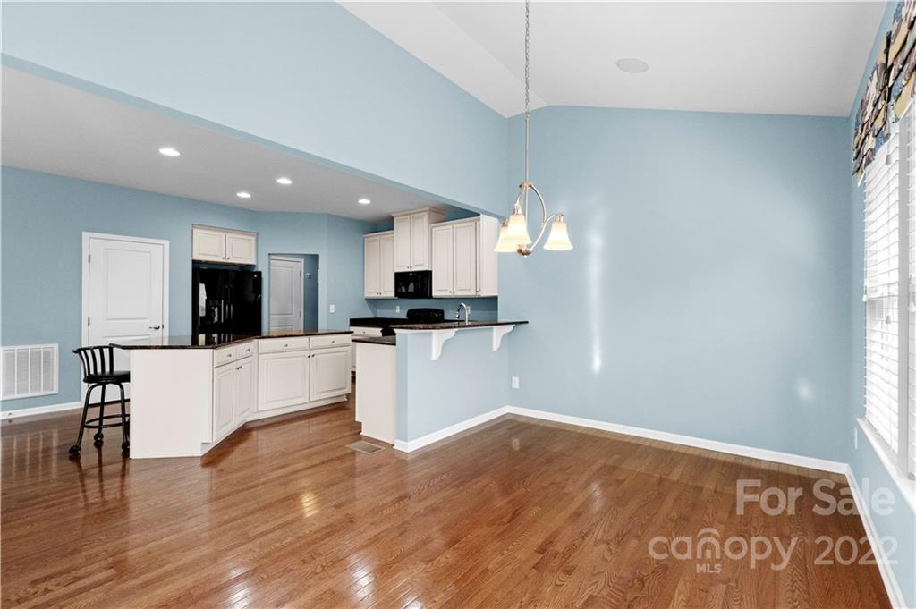 7720 East Berkeley Road Denver, NC 28037 - Photo 5 of 40 a view of kitchen with refrigerator microwave and wooden floor