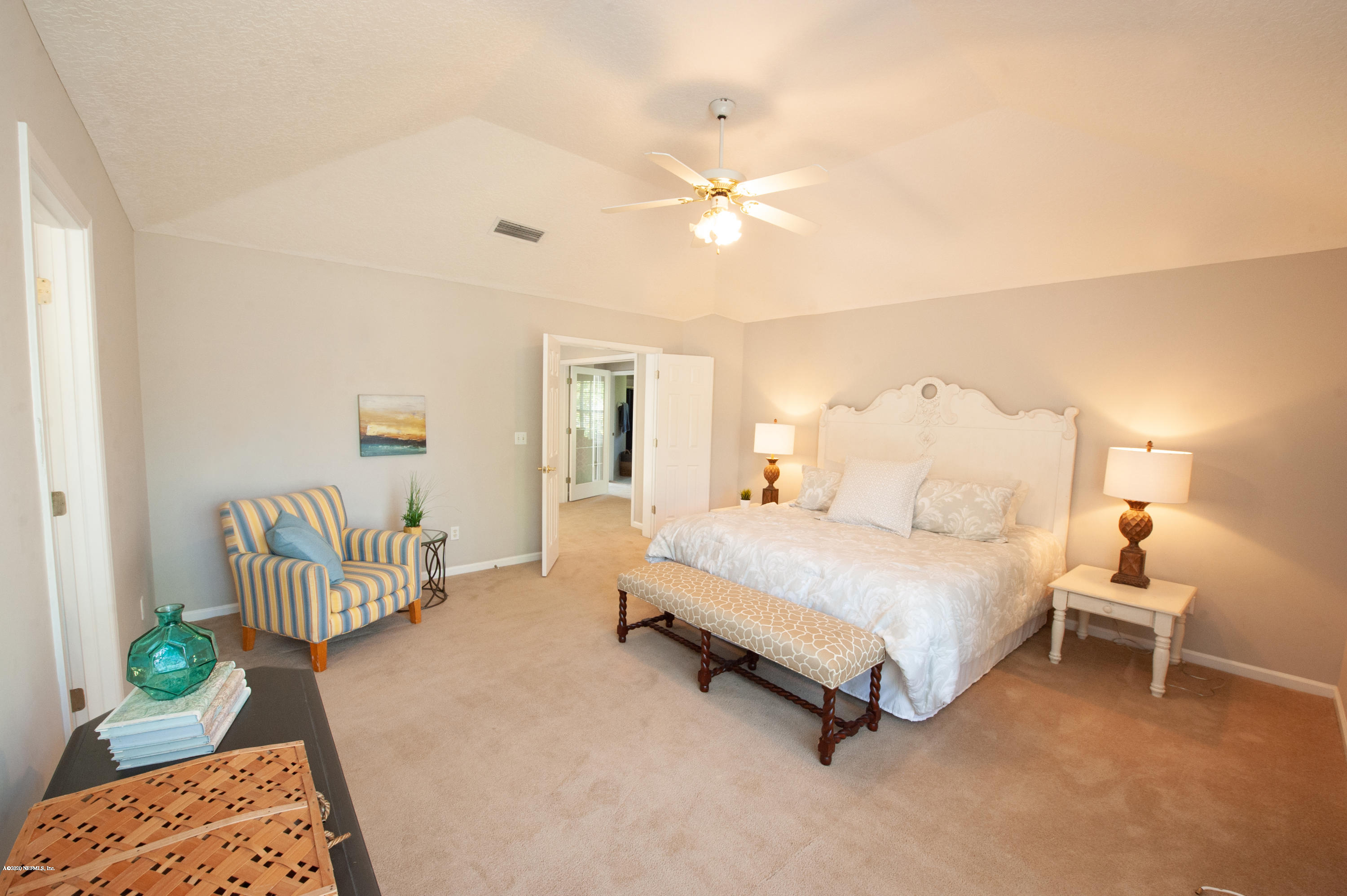 446 Big Tree Road Ponte Vedra Beach, FL 32082 - Photo 14 of 21 a spacious bedroom with a bed and a chandelier