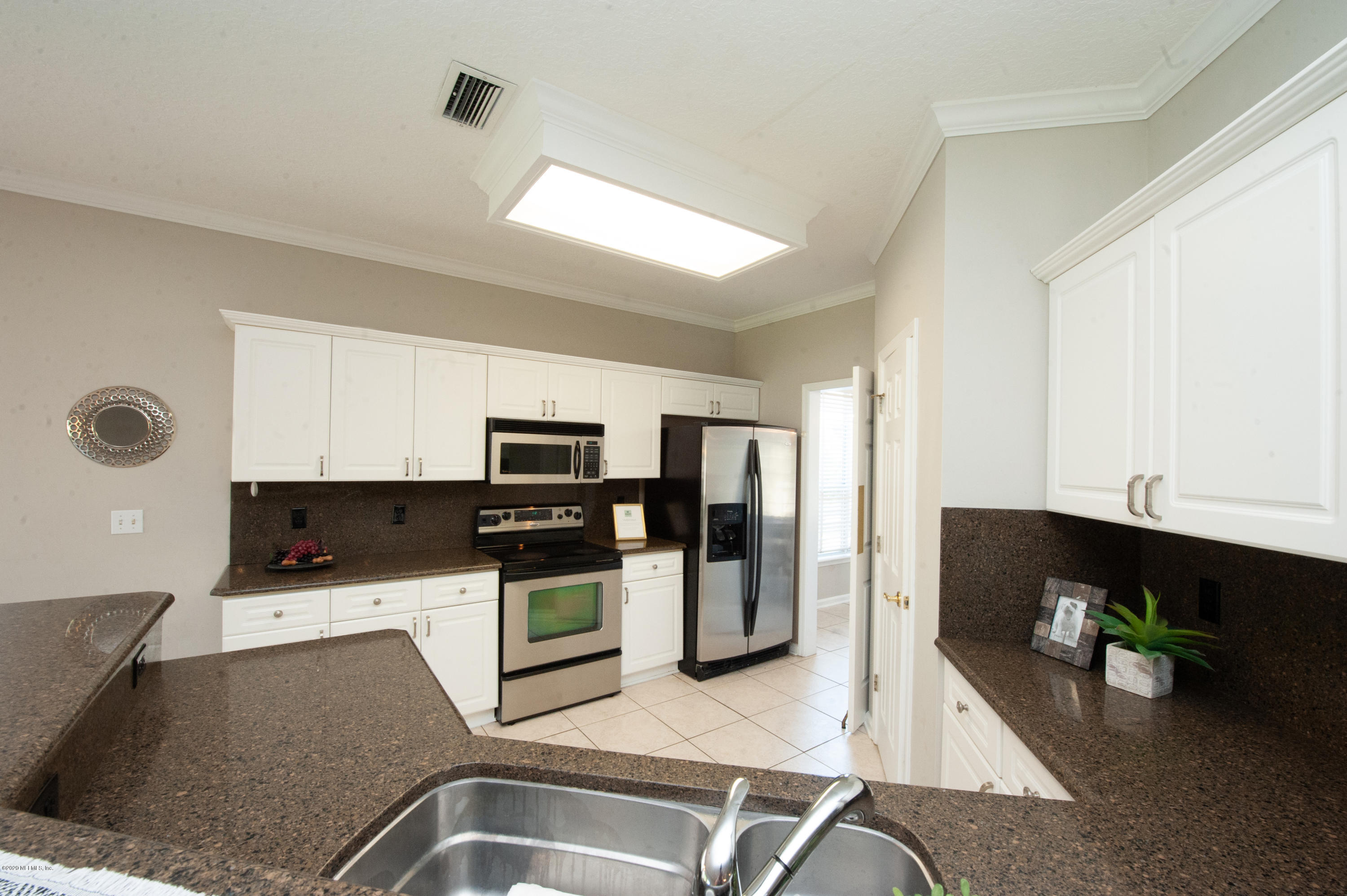 446 Big Tree Road Ponte Vedra Beach, FL 32082 - Photo 6 of 21 a kitchen with stainless steel appliances granite countertop a refrigerator and a sink