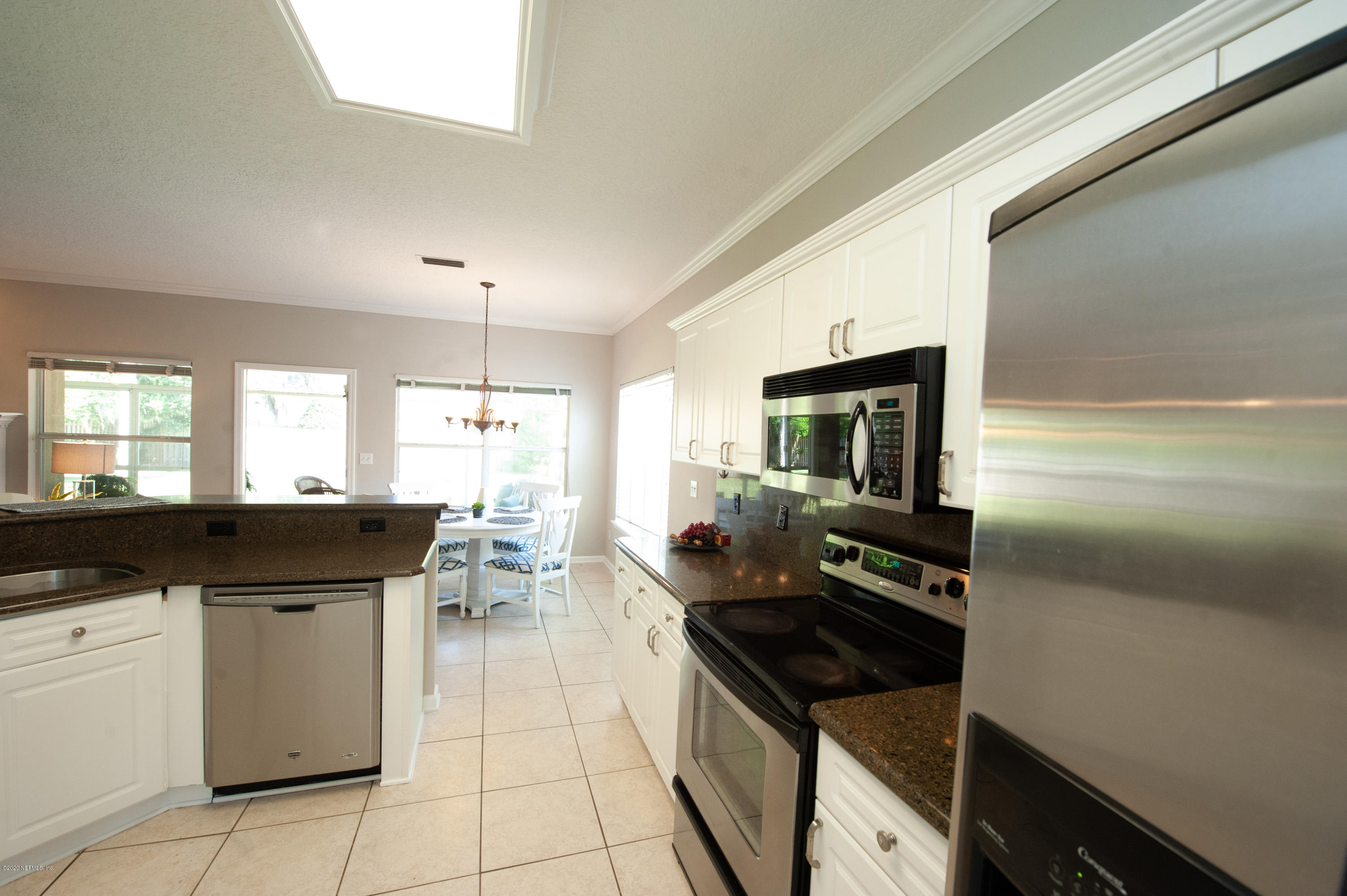 446 Big Tree Road Ponte Vedra Beach, FL 32082 - Photo 8 of 21 a kitchen with a sink a stove top oven and cabinets