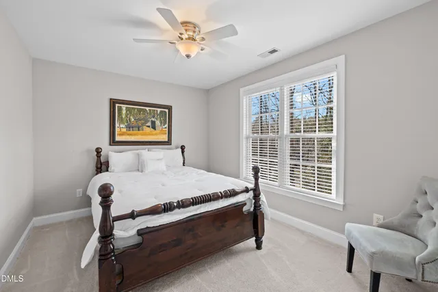 a front view of house with yard and trees in the background