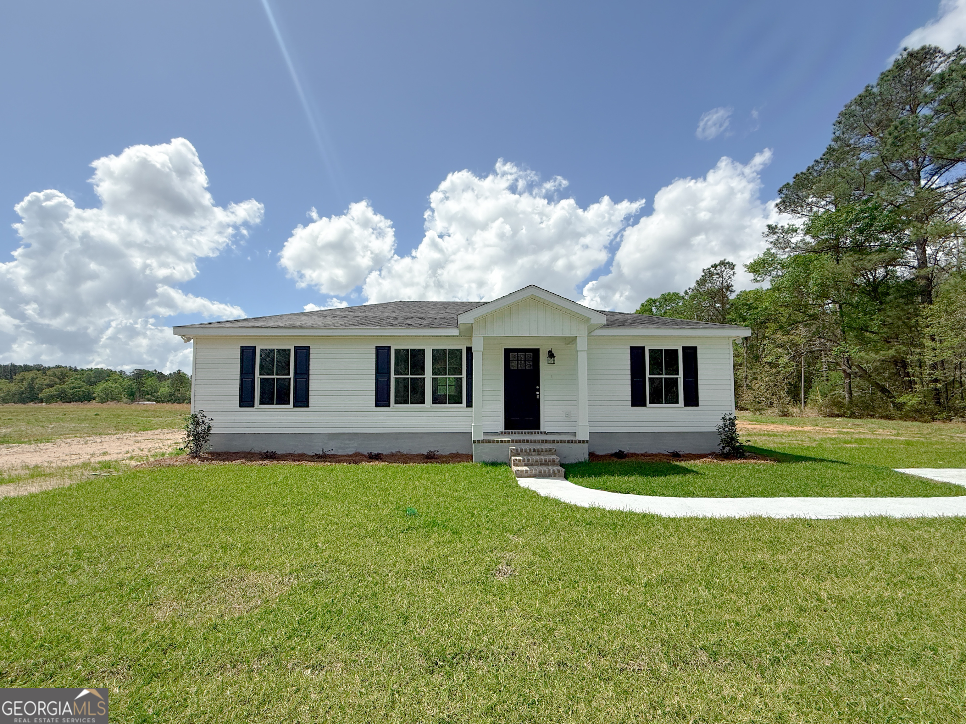 4348 Deloach Church Road Claxton, GA 30417 - Photo 1 of 1 a front view of a house with garden