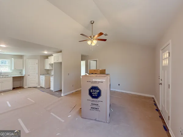 a very nice looking room with a window and a ceiling fan