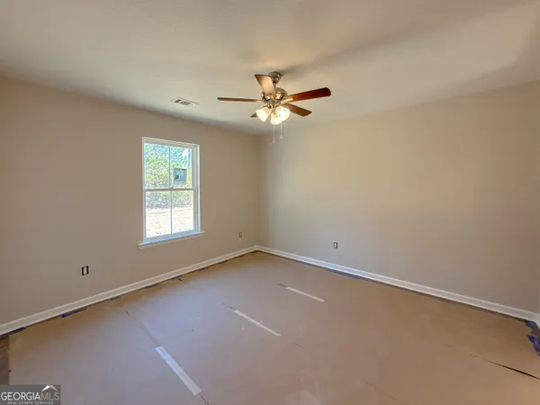 a view of an empty room with a ceiling fan