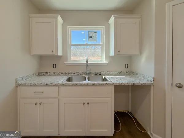 a bathroom with a granite countertop sink and a vanity