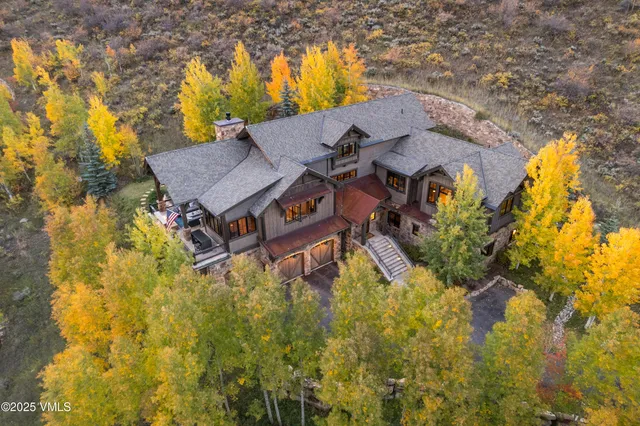 a aerial view of a house with swimming pool and lawn chairs