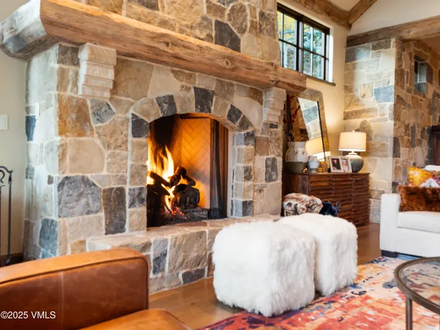 a living room with large couches and a flat tv screen next to a large window