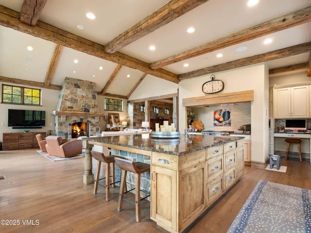 a view of a livingroom with a flesh screen tv and stairs