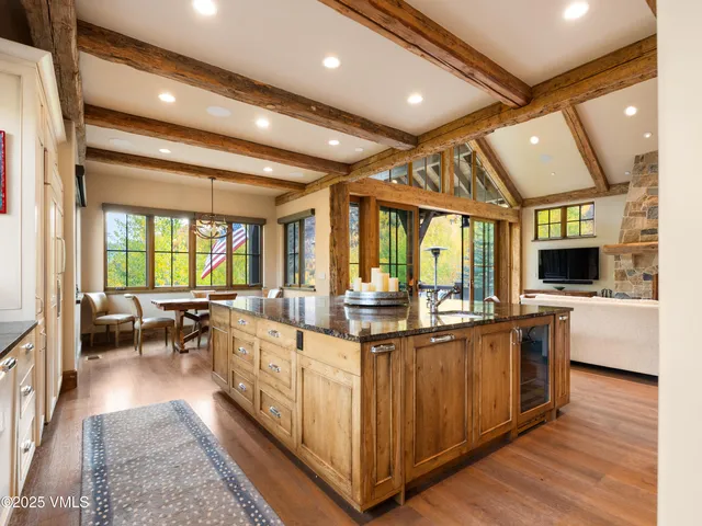 a bedroom with a bed and large windows