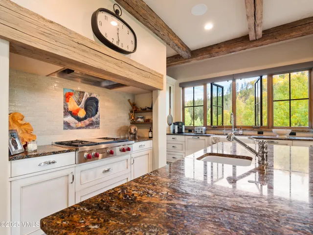 a bathroom with a sink a vanity a mirror and a bathtub
