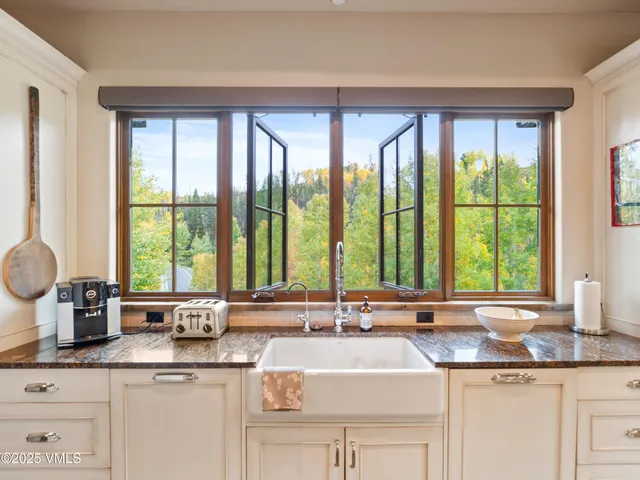 a spacious bathroom with a granite countertop sink and a mirror