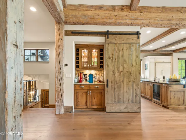a view of staircase with lots of frames on wall and wooden floor