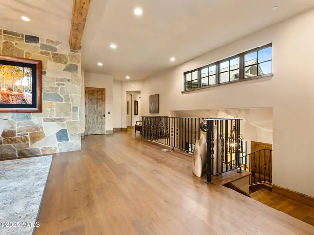 a bedroom with bed and wooden floor