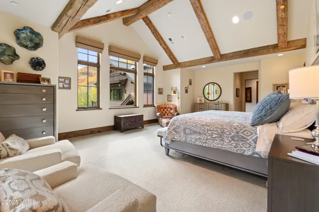 a living room with furniture a flat screen tv and a table