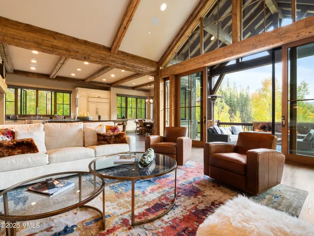 a living room with fireplace furniture and a large window