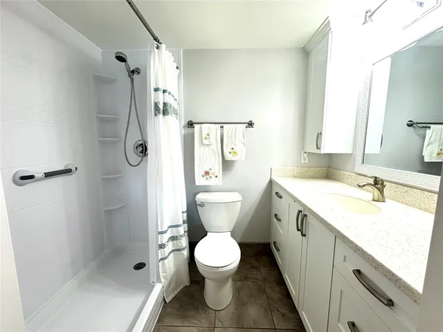 a bathroom with a shower curtain and a window
