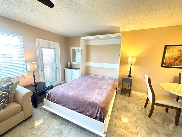 a bedroom with a bed and a chair