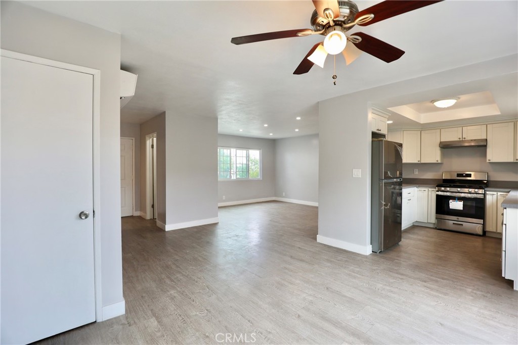 a view of kitchen with sink and refrigerator