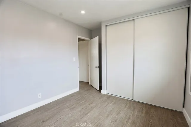 an empty room with wooden floor and a window
