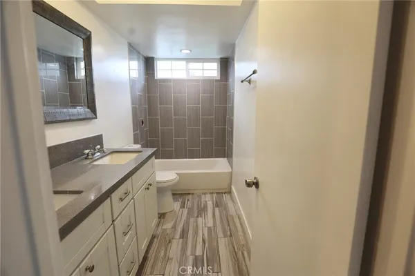 a bathroom with a sink a mirror and a bathtub