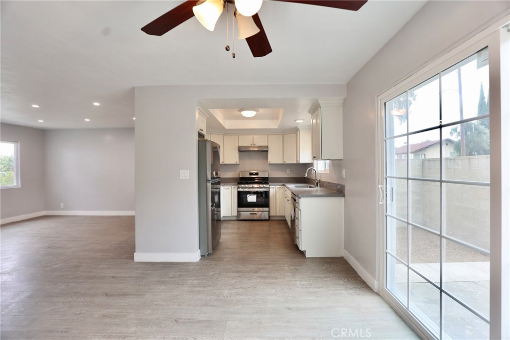1745 East Woodbury Road Pasadena, CA 91104 - Photo 4 of 18 a kitchen with stainless steel appliances kitchen island a large counter space a sink and a window