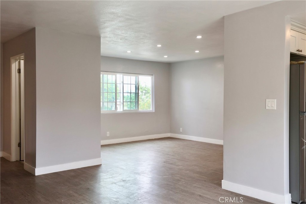 1745 East Woodbury Road Pasadena, CA 91104 - Photo 7 of 18 an empty room with wooden floor and windows