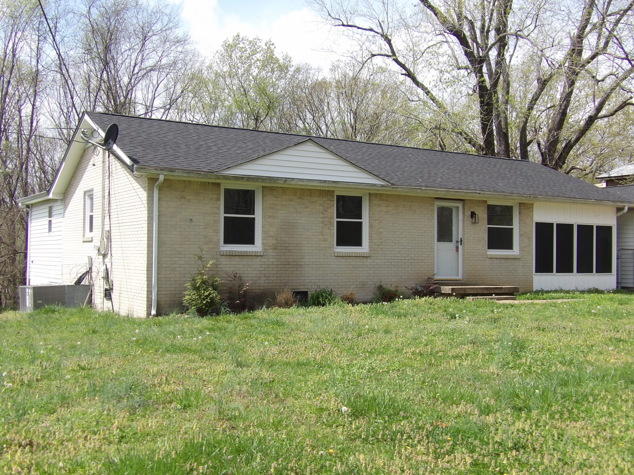 457 East Little Richland Road Waverly, TN 37185 - Photo 16 of 47 a backyard of a house with potted plants and large trees