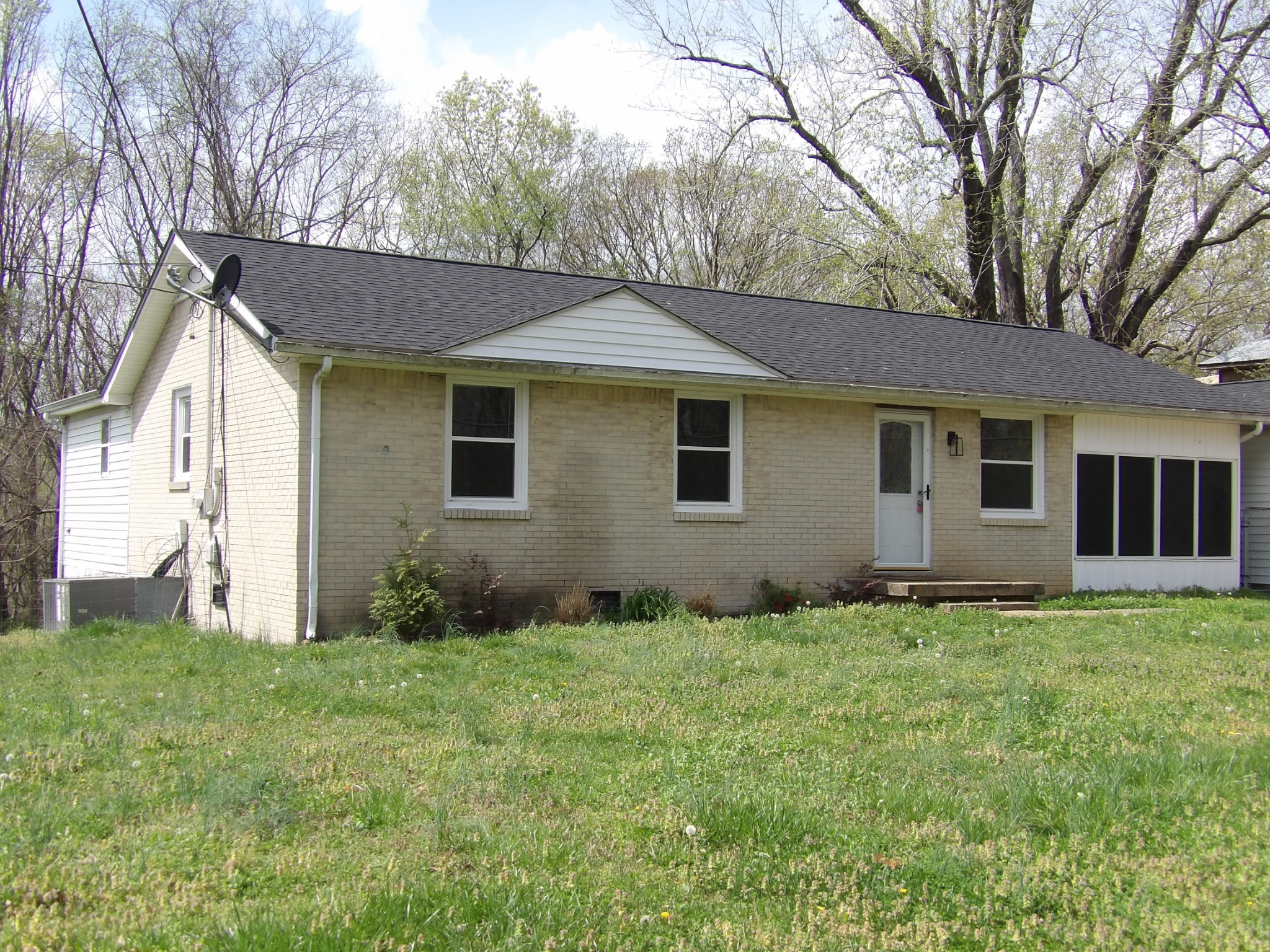 457 East Little Richland Road Waverly, TN 37185 - Photo 17 of 47 a backyard of a house with plants and large tree