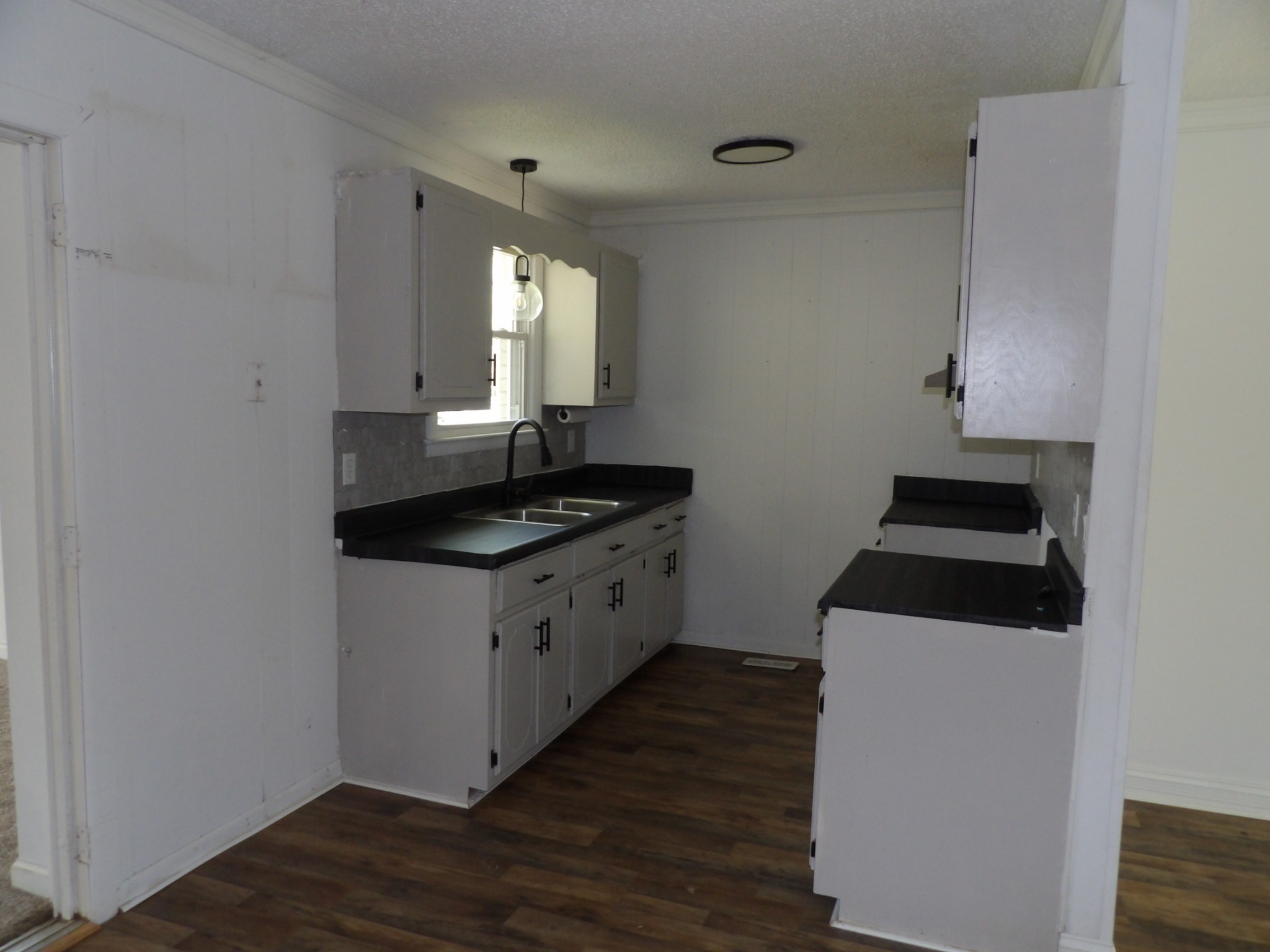 457 East Little Richland Road Waverly, TN 37185 - Photo 25 of 47 a kitchen with cabinets appliances and a wooden floor