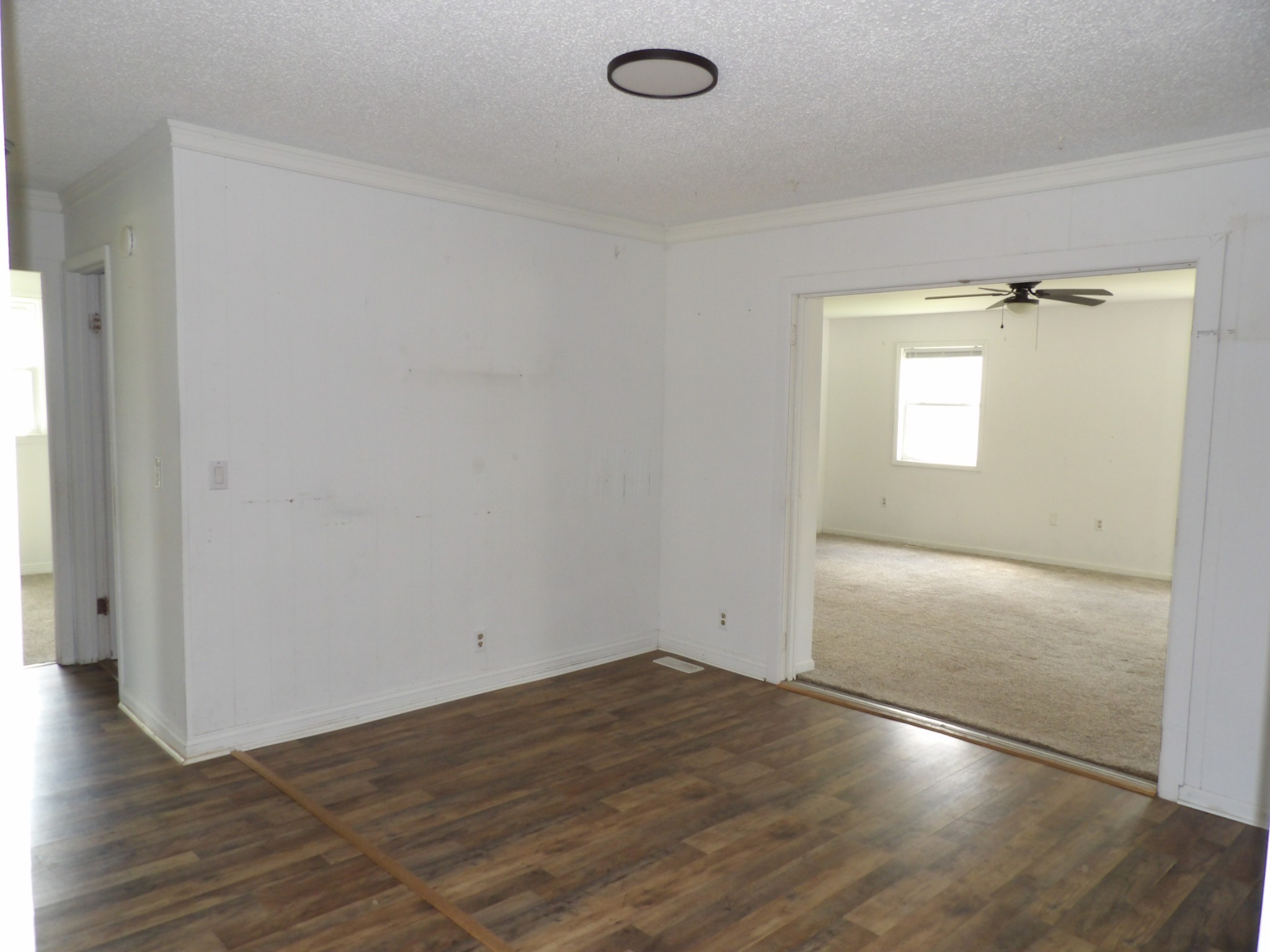 457 East Little Richland Road Waverly, TN 37185 - Photo 35 of 47 an empty room with wooden floor and windows