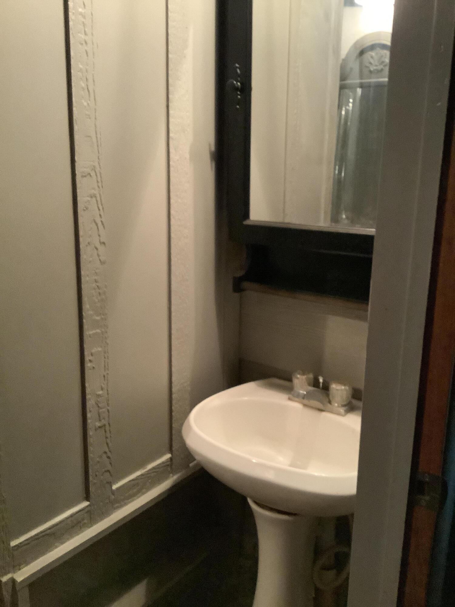 1203 South Date Plainview, TX 79072 - Photo 16 of 53 a bathroom with a sink and mirror