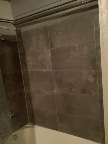 a bathroom with a shower and a sink