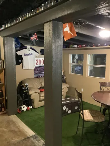 a living room with patio furniture and a potted plant