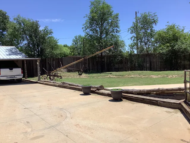 a view of a backyard with swimming pool