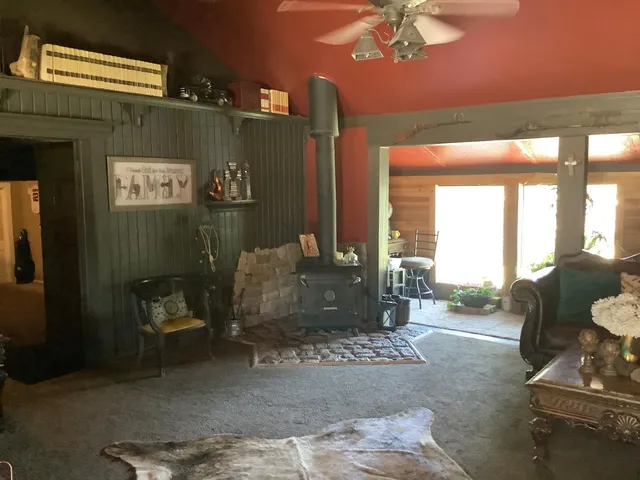 a living room with furniture and a floor to ceiling window