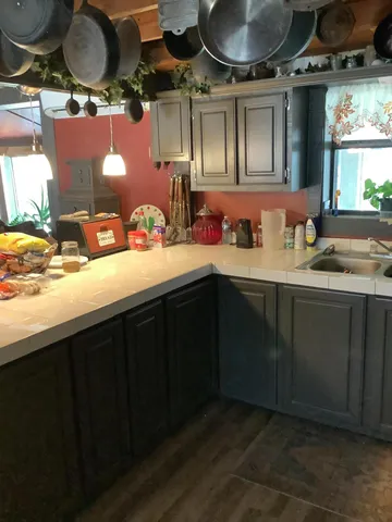 a kitchen with a sink a stove and cabinets