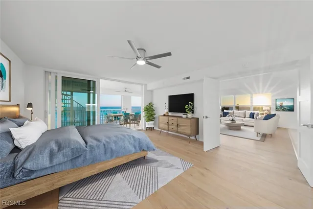 a living room with a bed furniture and a large window